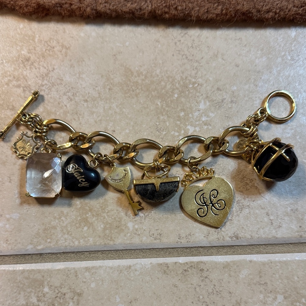 Juicy courture Gold Charm Bracelet with Black and Gold Accents